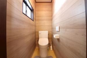 a bathroom with a toilet and wooden walls at TOHANA Style ペット宿泊可能 カラオケルーム有り in Hanamaki +38 photos