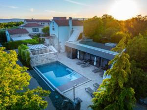 an aerial view of a house with a swimming pool at Luxury Jerini House with pool and wellness in Bajčići