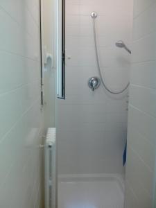a white bathroom with a shower and a toilet at Gabri Apartment in Monopoli