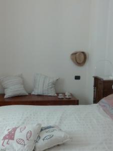 a bedroom with a bed with two pillows on it at Gabri Apartment in Monopoli