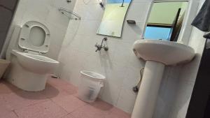 a bathroom with a toilet and a sink at Aralu in Bangalore +16 photos