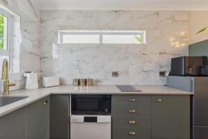a kitchen with a counter with a sink and a microwave at Lloyd's Corner in Cape Town