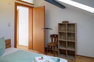 a bedroom with a bed and a closet and a door at Ferienwohnung Vögel in Langenegg