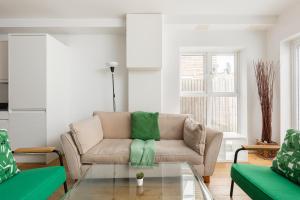 a living room with a couch and a glass table at New! Bright 2BR Flat with Patio in Elmers End