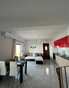 a kitchen and living room with a table and a bed at Sun Gazing Villas in Drymon