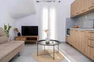 a living room with a coffee table and a television at Casa De Lago in Agios Nikolaos