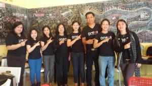 a group of people in black shirts posing for a picture at The Hive Singapore Hostel in Singapore