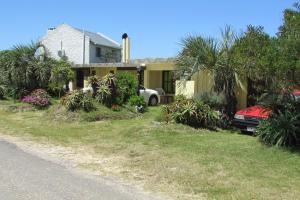 a house with a car parked in front of it at La Nueva Ensenada in La Paloma