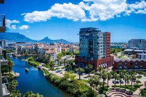 a view of a city with a river and buildings at Knightsbridge Luxury Apartments in Cape Town