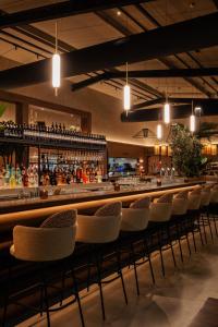 a bar with a row of chairs in a restaurant at Hotel van der Valk Spier Dwingeloo in Spier