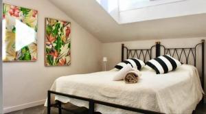 a bedroom with a bed with black and white pillows at Casa Carletti in Chivasso
