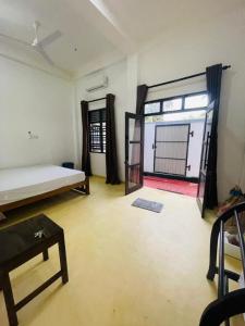 a room with a bed and an open door at Janaka Villa - Ahangama in Ahangama