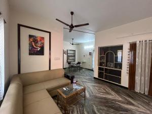a living room with a couch and a table at Grey Pearl Homestay in Pondicherry