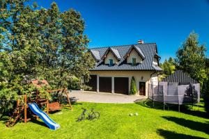 ein Haus mit Spielplatz im Hof in der Unterkunft Chochołowskie apartamenty in Chochołów