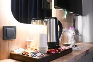 a kitchen counter with a coffee maker on a tray at Nas Corner Hotel in Antalya