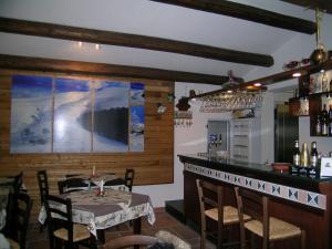 een eetkamer met een tafel en een bar bij Les Chalets B&B in Villetta Barrea