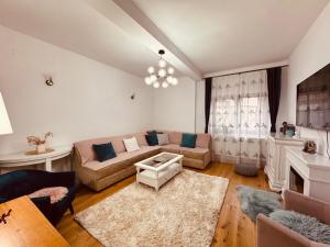 a living room with a couch and a table at Andrei's house in Sinaia
