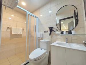 a bathroom with a toilet and a sink and a mirror at 悠而行旅 in Nangan +35 photos
