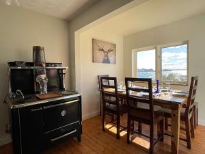 a dining room with a wooden table and chairs at The Moose Twillingate Island in Twillingate