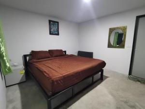 a bedroom with a bed in a white room at The Relax Resort in Ko Phangan