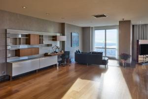 a large living room with a desk and a couch at Fraser Place Anthill Istanbul in Istanbul
