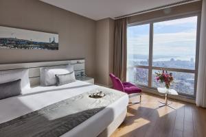 a bedroom with a large bed and a large window at Fraser Place Anthill Istanbul in Istanbul