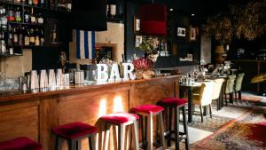 a bar with red stools in a restaurant at Hotel Ramblas Internacional in Barcelona