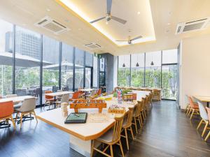 a cafeteria with tables and chairs and windows at Osaka View Hotel Honmachi in Osaka