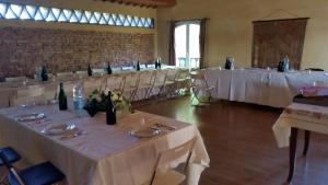 a room with rows of tables with white table linen at B&B La Palazza in Russi +51 photos