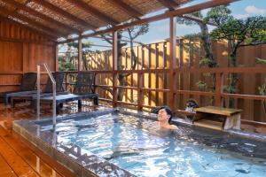 a woman in a swimming pool in a house at Ooedo Onsen Monogatari Premium Shima Saichoraku in Shima +57 photos