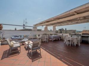 a patio with tables and chairs on a roof at B&B Antiche Porte in Rimini