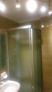 a bathroom with a glass shower and a sink at Monolocale Milky Way - Sestriere in Sestriere