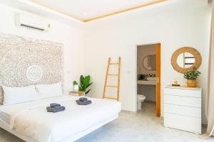 a bedroom with a white bed with towels on it at Villa Laura 2Br & Private Pool in Mae Nam in Mae Nam +20 photos