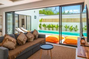 a living room with a couch and a pool at Villa Laura 2Br & Private Pool in Mae Nam in Mae Nam
