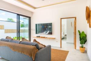 a living room with a couch and a tv at Villa Laura 2Br & Private Pool in Mae Nam in Mae Nam
