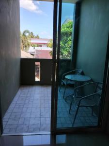 a view of a balcony with two chairs and a table at Spy Home apartment in Khao Lak