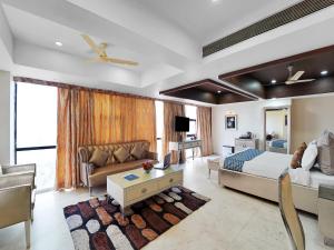 a large bedroom with a bed and a couch at Palette Orient Hotel & Convention Centre by CheckIn, Nagpur in Nagpur
