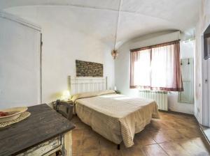 a bedroom with a bed and a table and a window at B&B Antiche Porte in Rimini