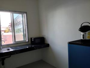 a kitchen with a sink and a window at Spy Home apartment in Khao Lak