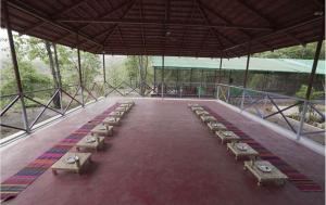 a row of benches in a pavilion in a field at Gaudham Periyar Farms in Jambhulpāda +6 photos