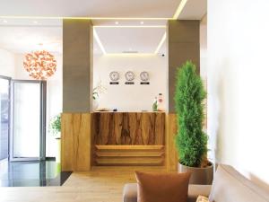 a lobby with a reception desk and a potted plant at Smarts Hotel Agdal Rabat in Rabat