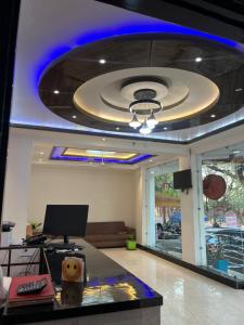 a lobby with a ceiling with a blue light at Hotel Ashok Palace in Agra