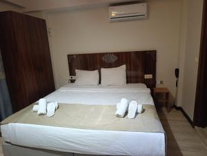 a bedroom with a large bed with white towels on it at Siesta Apart Otel İzmir in İzmir +103 photos