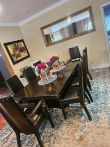 a dining room with a black table and chairs at 20 in Crescent in Gqeberha