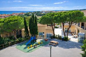 an aerial view of a playground with a slide at ULVF Les Romarins in Fleury +12 photos