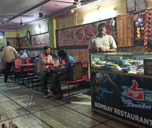 a group of people sitting at a table in a restaurant at Sunlight Dormitory in Mumbai +44 photos