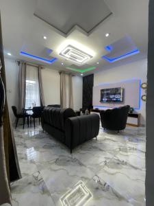 a living room with a couch and a table at 6c Apartment in Port Harcourt