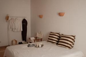 a bedroom with a white bed with two pillows and a closet at La Molina Mallorca in Felanitx +51 photos