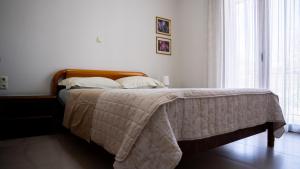 a bedroom with a bed with a blanket on it at Η Αυλή της Μαρίας in Áyios Thomás