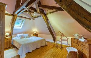 a bedroom with a bed and a dresser at Les Bouyssières in Creysse
